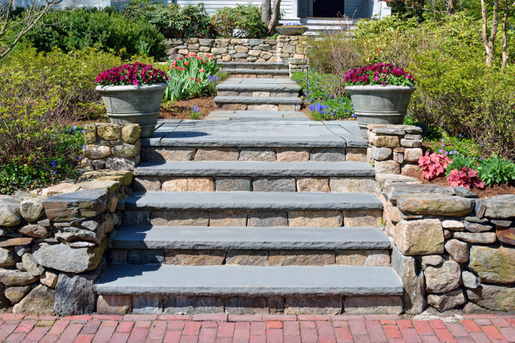 Home entrance walkway with stone wall and stepping stones in Huntsville, AL