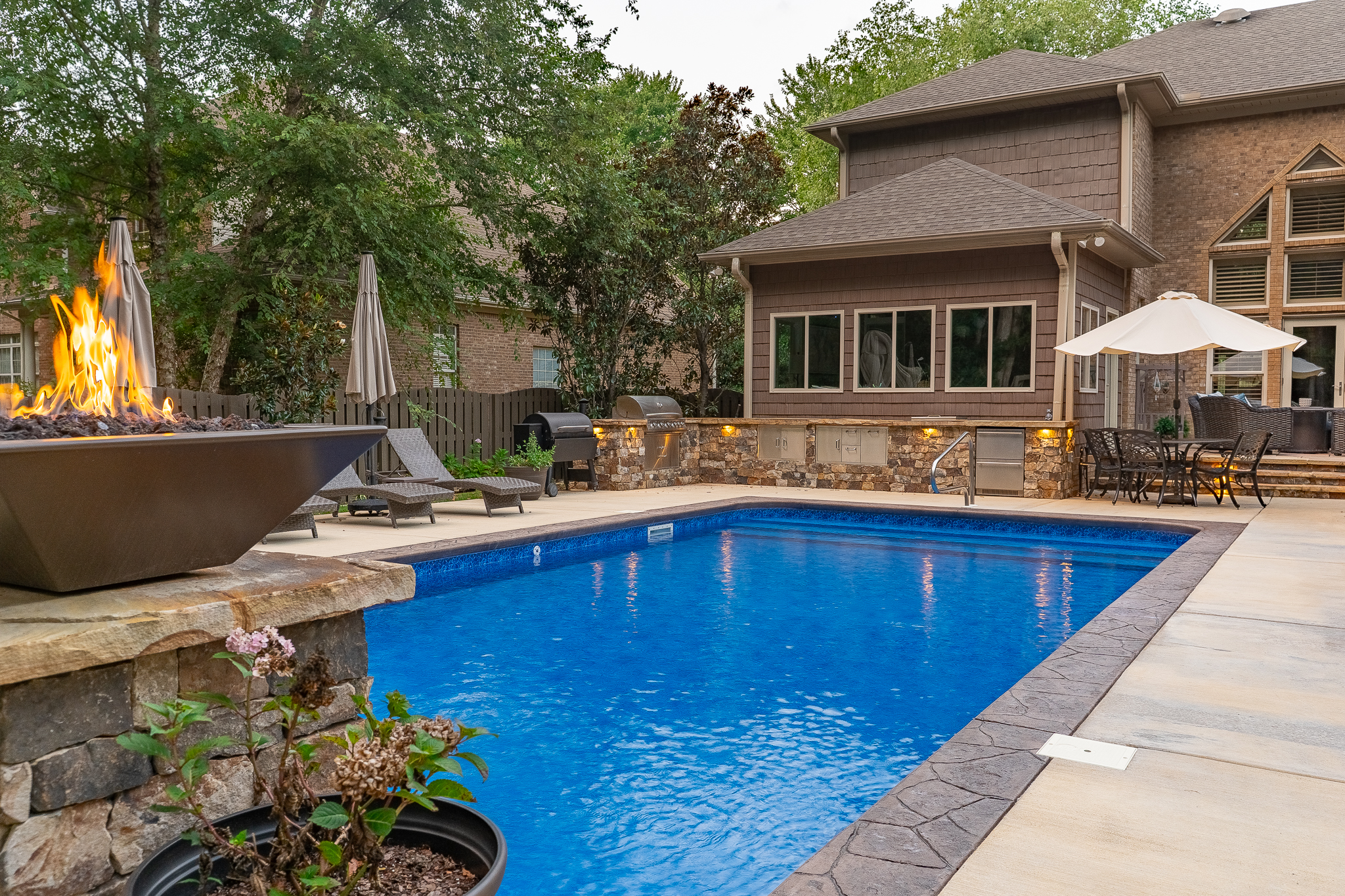 Fiberglass backyard pool design by Greenscapes Outdoor Living in Madison, AL
