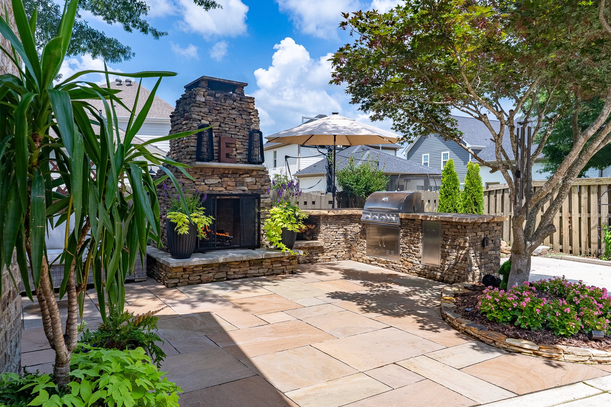 Outdoor kitchen and fire pit backyard design by Matt at Greenscapes Outdoor Living in Huntsville