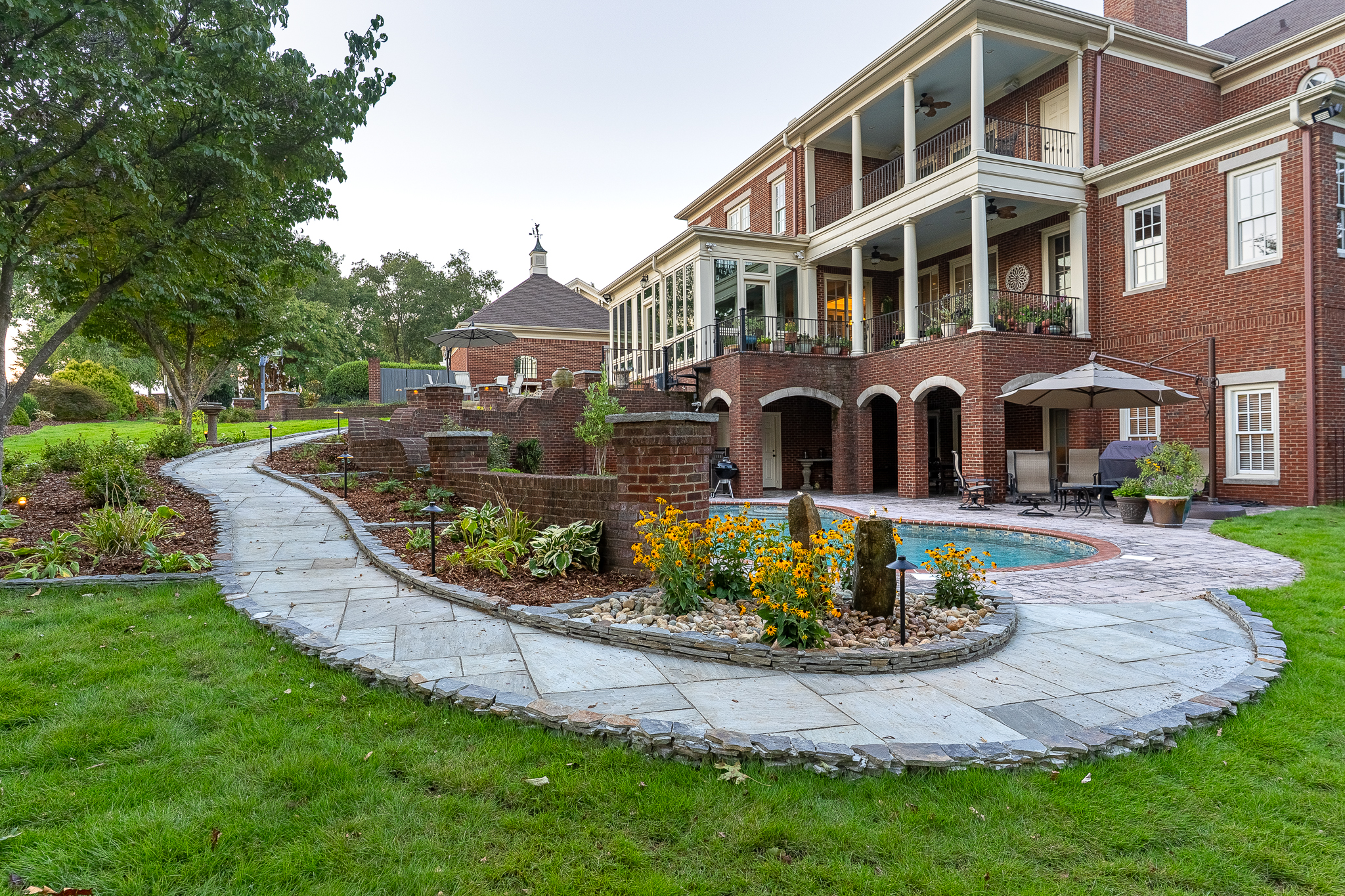 A pool hardscape design by Greenscapes Outdoor Living in Huntsville, AL at The Ledges